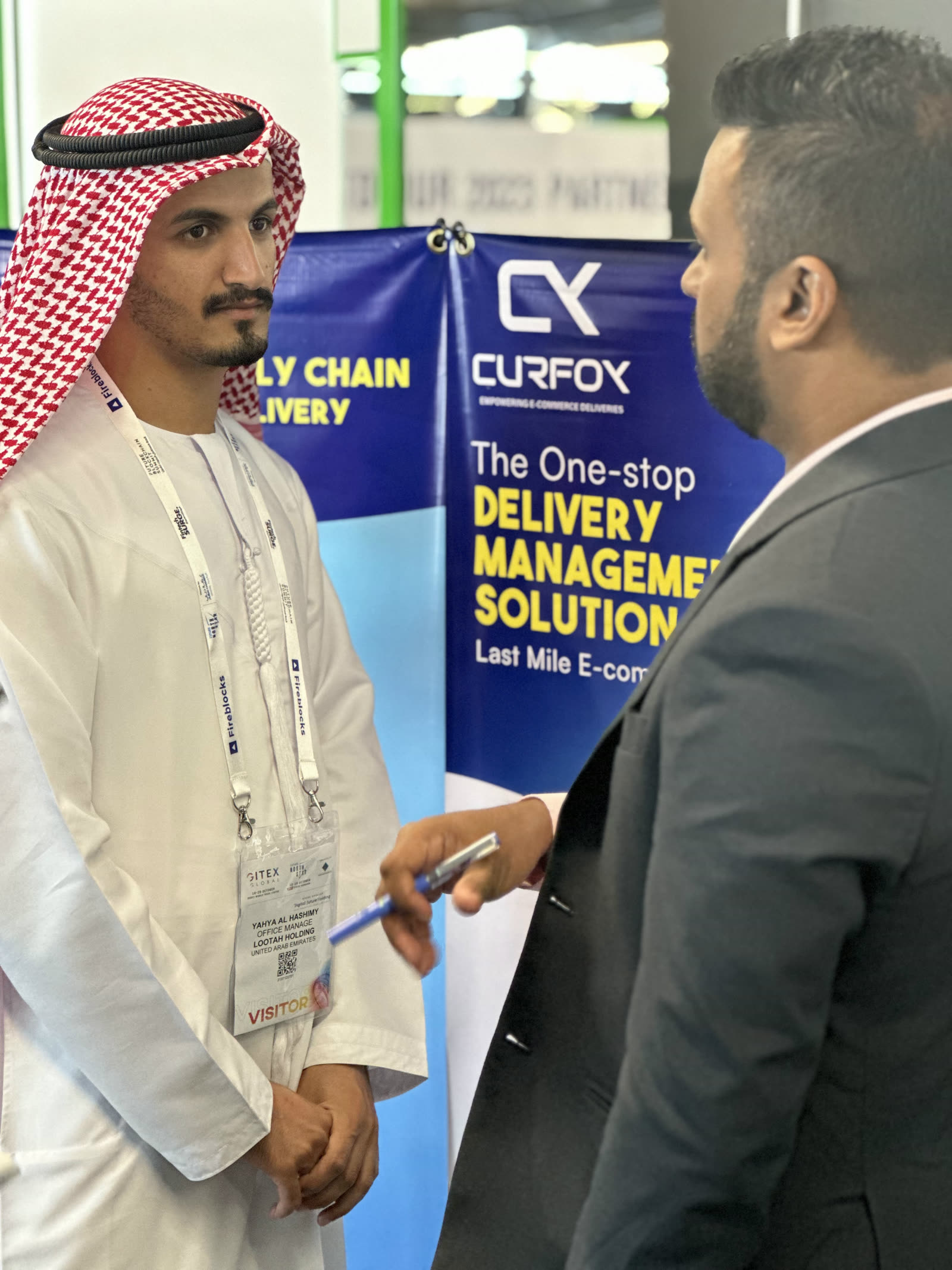 Namal Attanayake speaking with a visitor beside the Curfox banner in Dubai