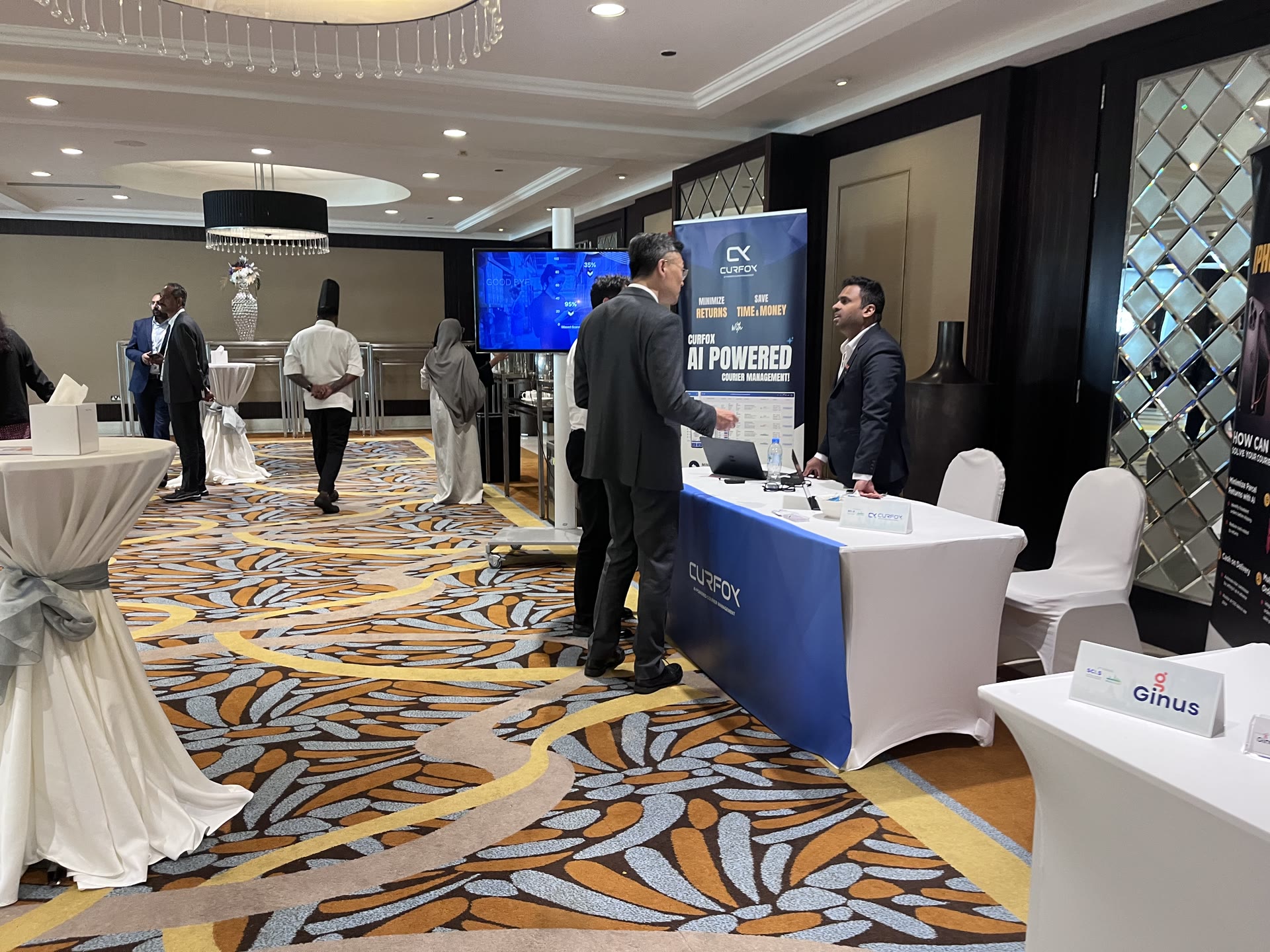 Namal Attanayake speaking with visitors at the Curfox exhibition table