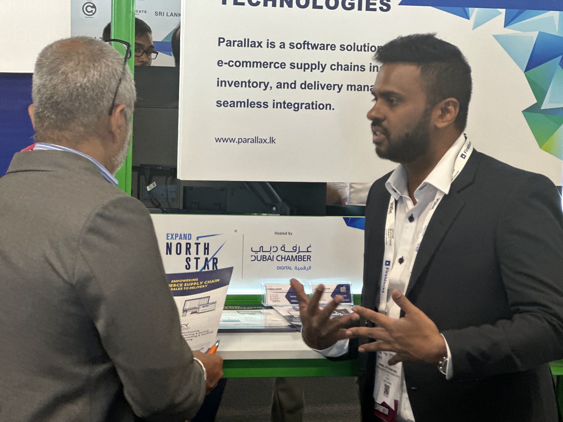Namal Attanayake explaining Parallax software to a visitor at the company's stand in Dubai