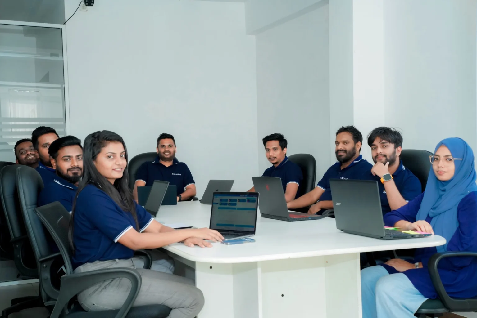 Namal Attanayake with members of the Parallax team around a meeting table at the Parallax office